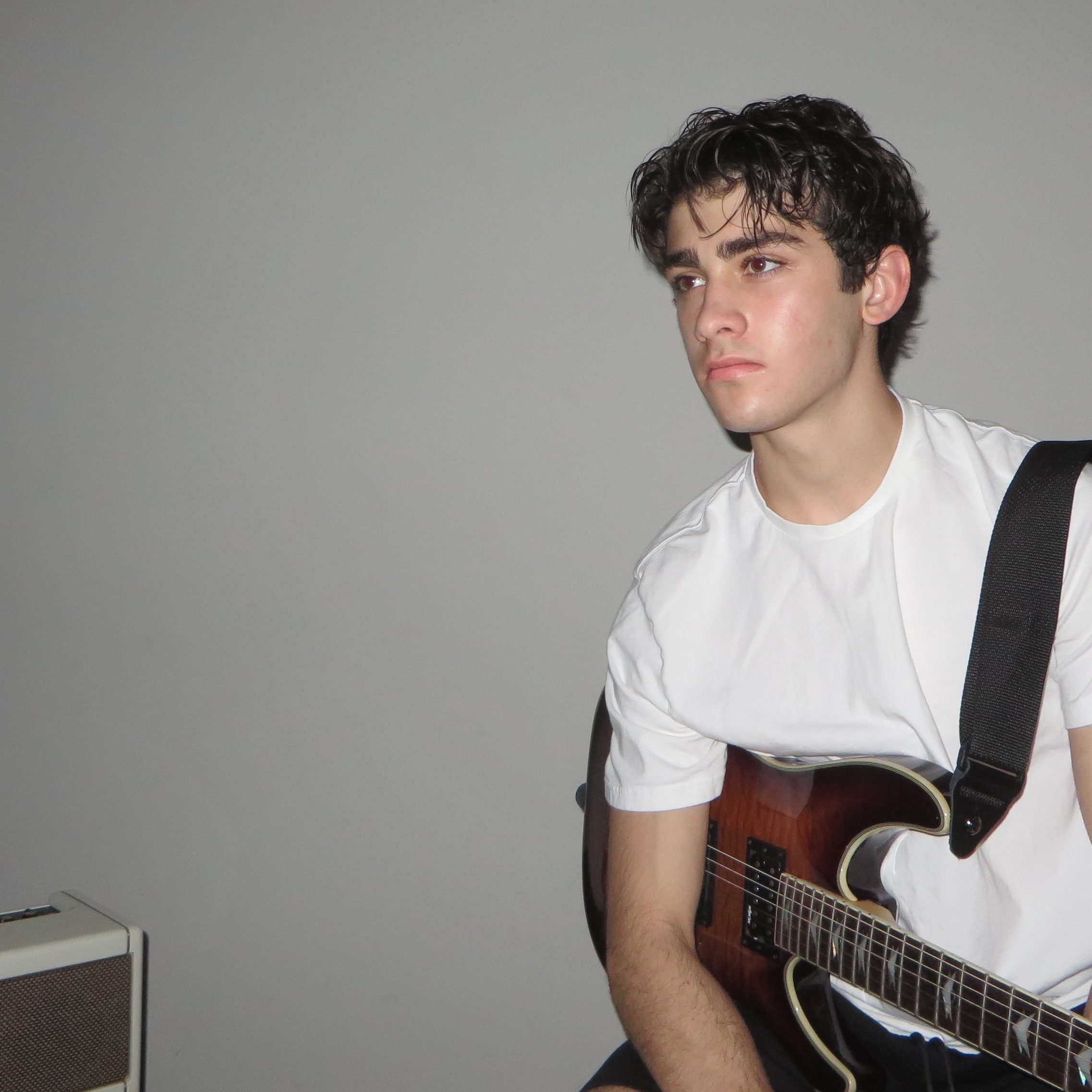 Image of Aiden Khanna posing with guitar